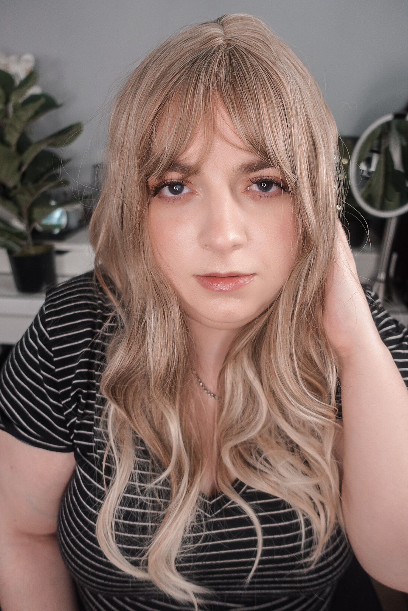 Haircube blonde synthetic wig front view showing curtain bangs and warm blonde tones - worn by Neveen Wood